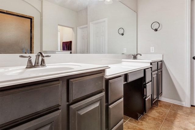 full bath with tile patterned flooring, double vanity, and a sink