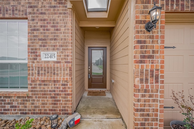 doorway to property featuring brick siding