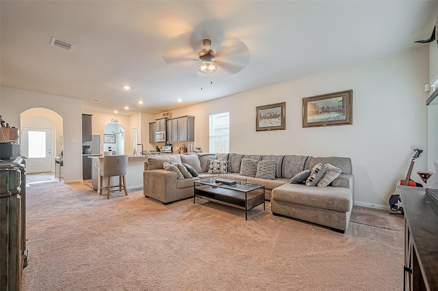 living room with light carpet, a wealth of natural light, and visible vents