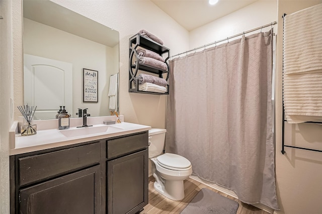 full bathroom with a shower with curtain, vanity, toilet, and wood finished floors