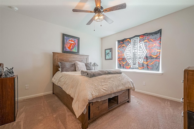 bedroom featuring light carpet, a ceiling fan, and baseboards