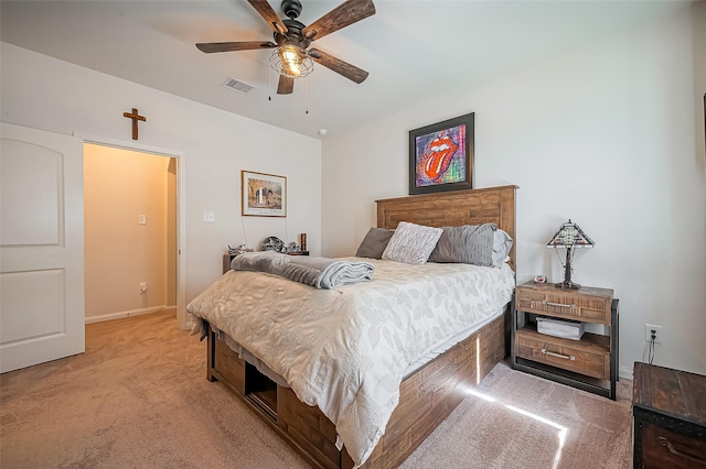 bedroom featuring baseboards, a ceiling fan, visible vents, and light colored carpet