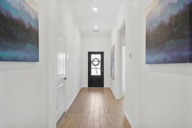 doorway to outside with recessed lighting, crown molding, baseboards, and wood finished floors