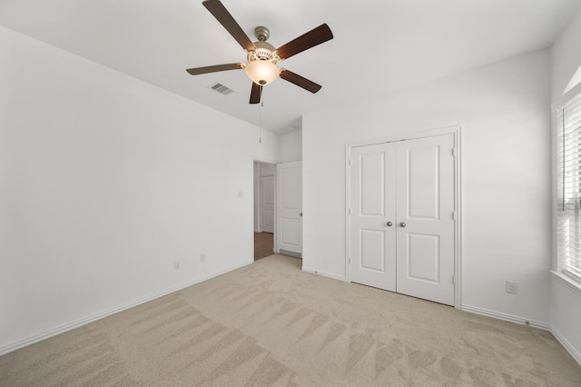 unfurnished bedroom with baseboards, visible vents, and light colored carpet