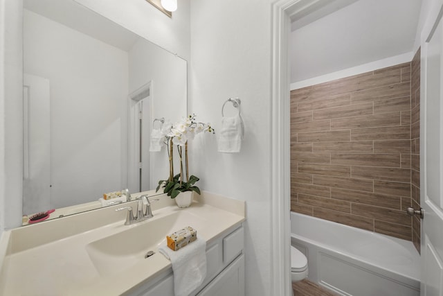 bathroom with toilet,  shower combination, and vanity