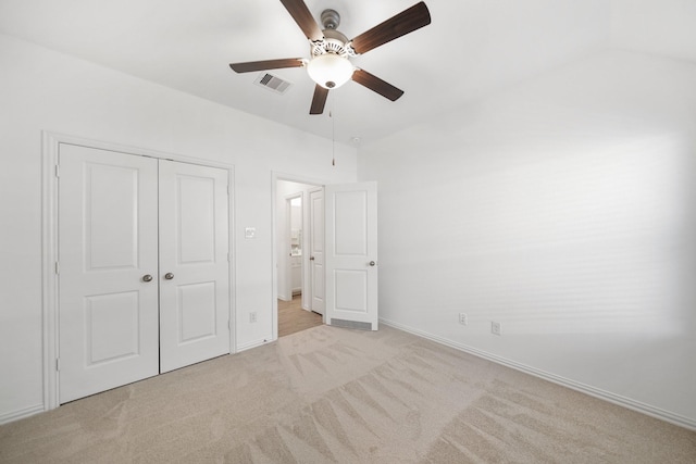 unfurnished bedroom featuring light carpet, a ceiling fan, visible vents, baseboards, and a closet