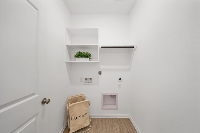 clothes washing area with hookup for a washing machine, hookup for a gas dryer, hookup for an electric dryer, wood finished floors, and laundry area