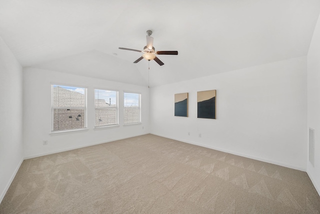 unfurnished room with ceiling fan, baseboards, vaulted ceiling, and light colored carpet