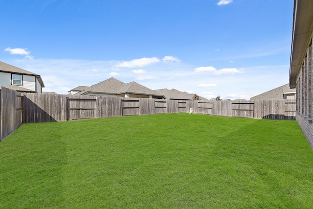 view of yard with a fenced backyard