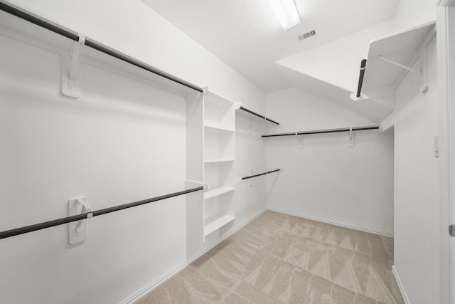 walk in closet featuring light colored carpet and visible vents