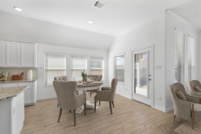 dining area featuring a wealth of natural light, visible vents, and light wood-style floors