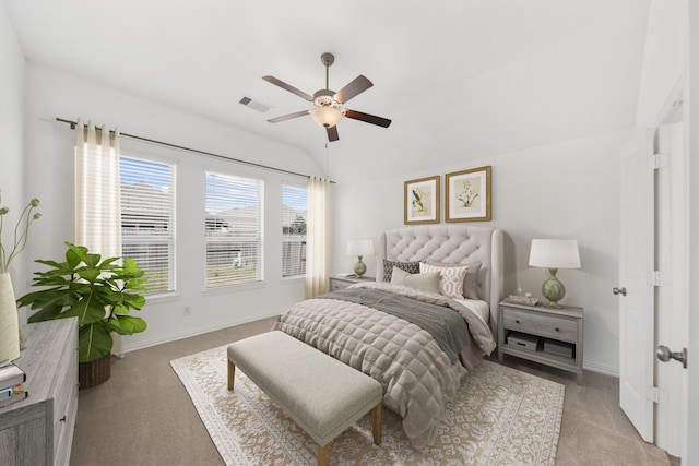 bedroom featuring lofted ceiling, baseboards, light carpet, and visible vents