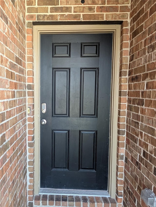 property entrance with brick siding