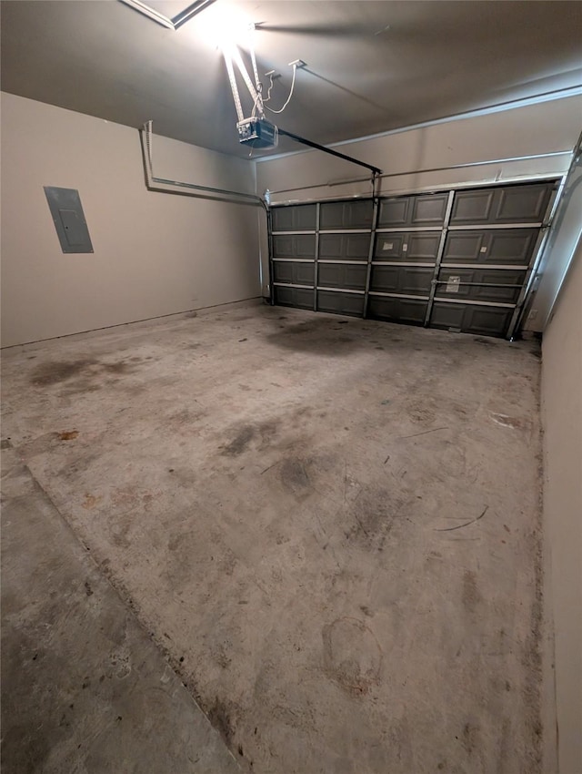 garage with a garage door opener and electric panel