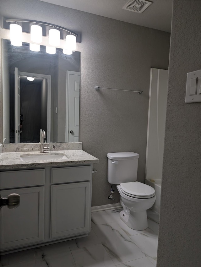 full bathroom featuring toilet, marble finish floor, visible vents, and vanity