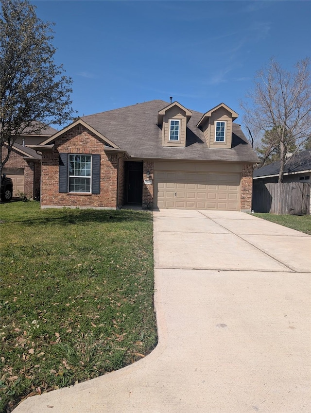 view of front of home featuring a garage, concrete driveway, brick siding, and a front yard