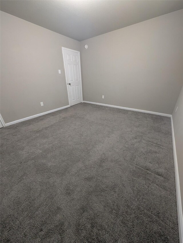 spare room with carpet flooring and baseboards