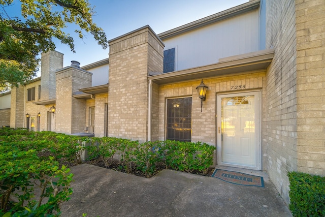 entrance to property with brick siding