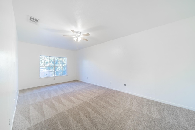 unfurnished room featuring visible vents, ceiling fan, light carpet, and baseboards