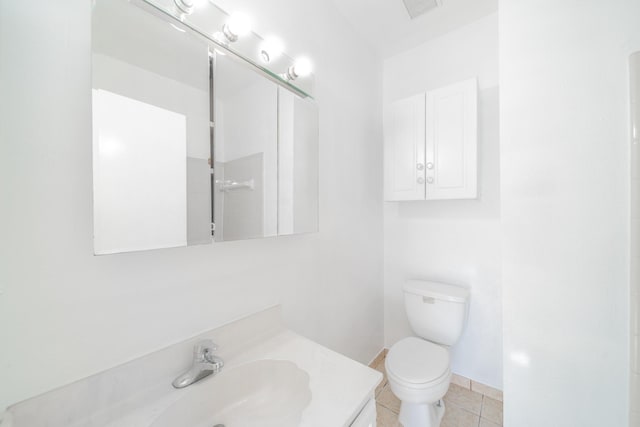 full bath with baseboards, vanity, toilet, and tile patterned floors