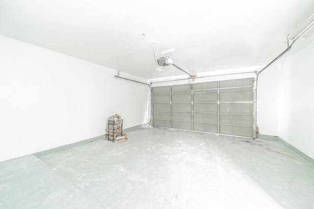 garage featuring a garage door opener and baseboards