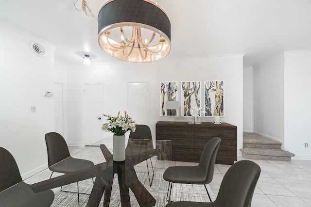 dining space with light tile patterned floors, visible vents, baseboards, an inviting chandelier, and crown molding