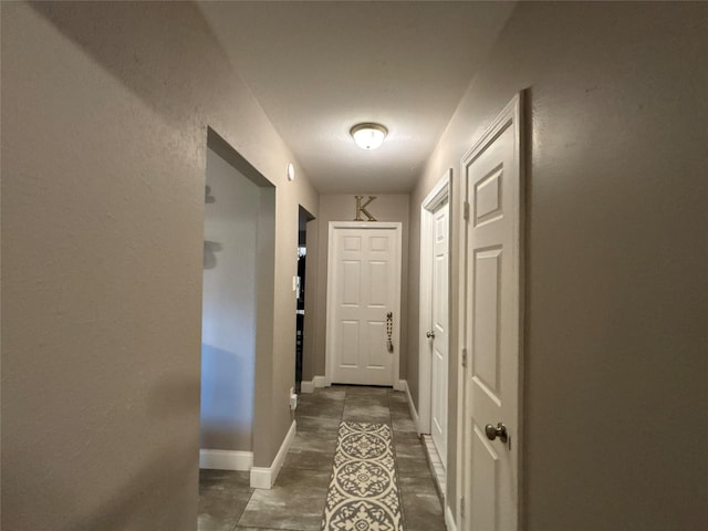 corridor featuring baseboards