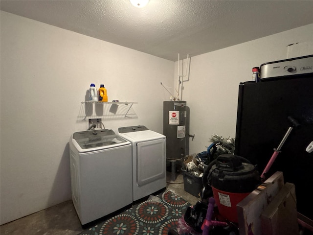 clothes washing area featuring washer and dryer, laundry area, water heater, and a textured ceiling