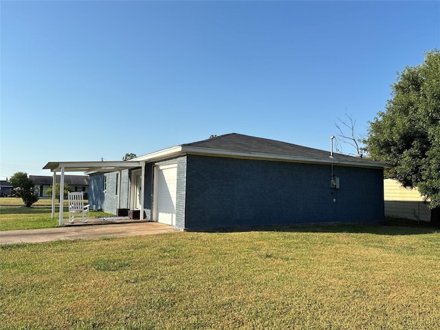 view of property exterior with brick siding, a carport, concrete driveway, a lawn, and a garage