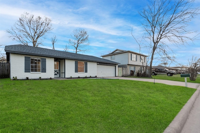 view of front of property with an attached garage, brick siding, fence, concrete driveway, and a front lawn