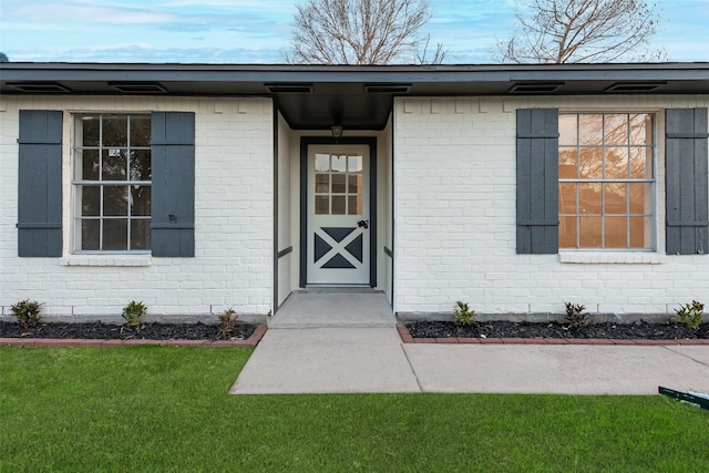 doorway to property featuring a yard