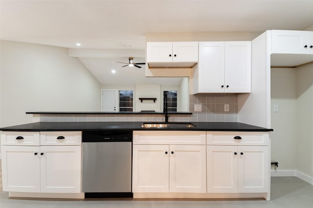 kitchen with white cabinets, dishwasher, dark countertops, backsplash, and a sink