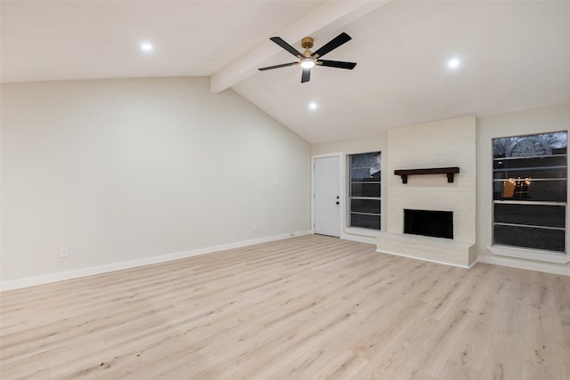 unfurnished living room with vaulted ceiling with beams, light wood-style flooring, a fireplace, a ceiling fan, and baseboards