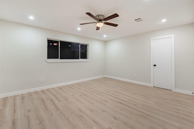 unfurnished room featuring light wood finished floors, baseboards, and visible vents