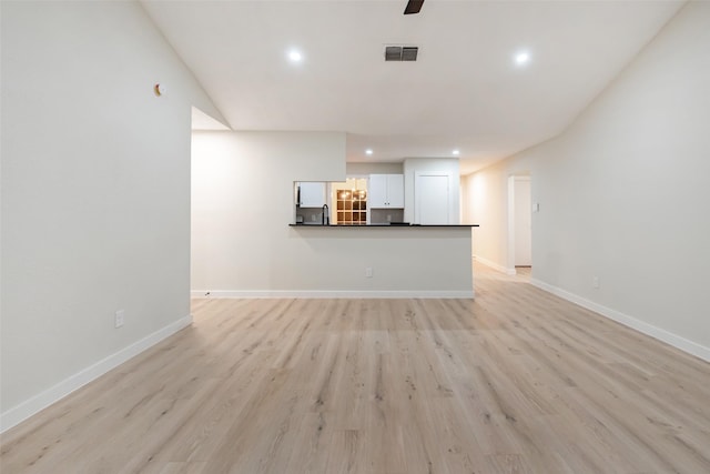 unfurnished living room with recessed lighting, light wood-type flooring, visible vents, and baseboards