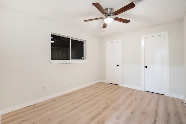 unfurnished bedroom with ceiling fan, baseboards, and wood finished floors