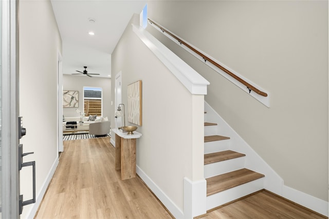 stairs with a ceiling fan, recessed lighting, baseboards, and wood finished floors