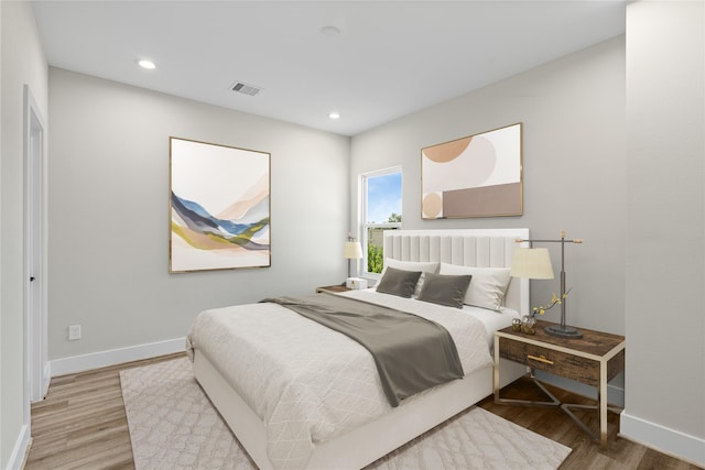 bedroom featuring recessed lighting, visible vents, baseboards, and wood finished floors