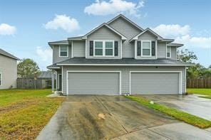 view of front facade featuring a garage, aphalt driveway, and a front yard