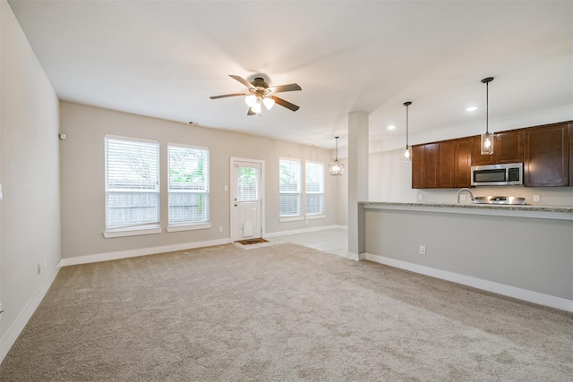 unfurnished living room featuring light carpet, baseboards, a ceiling fan, and recessed lighting