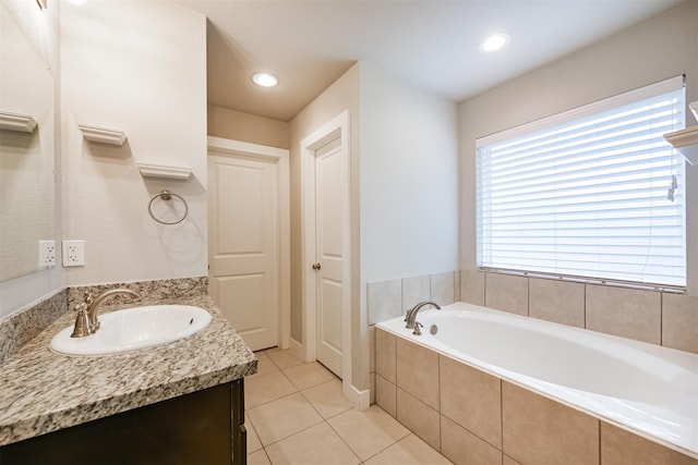 bathroom with tile patterned flooring, a garden tub, vanity, and recessed lighting