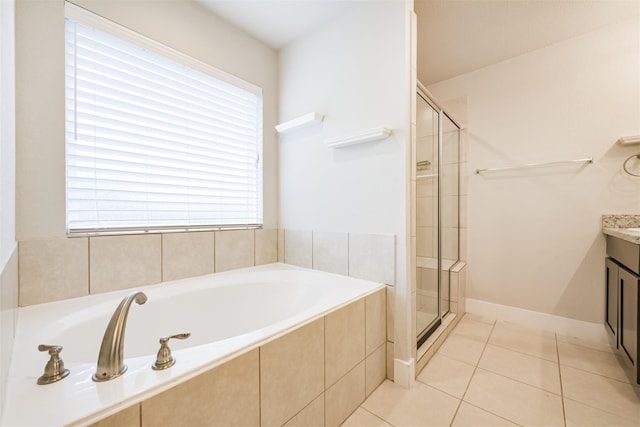 full bathroom with a stall shower, a garden tub, and plenty of natural light