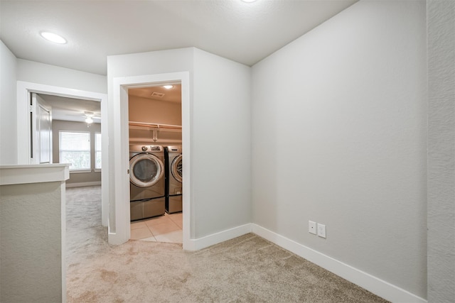 laundry room featuring carpet floors, washing machine and clothes dryer, visible vents, laundry area, and baseboards