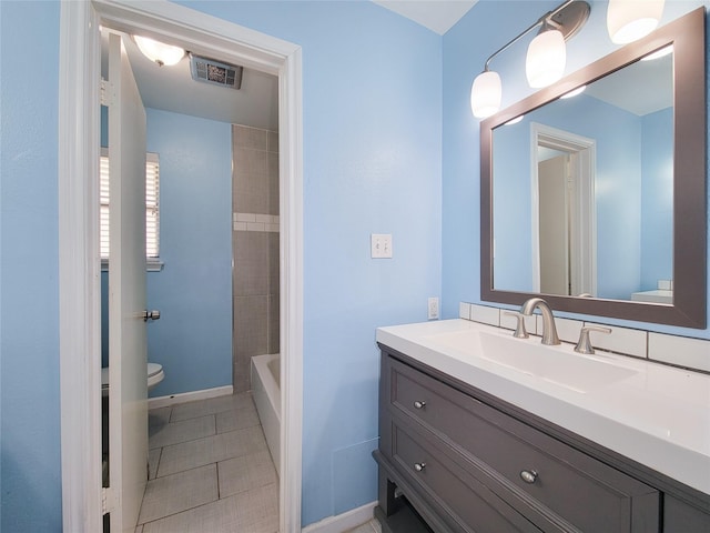 bathroom featuring visible vents, toilet, vanity, tile patterned flooring, and walk in shower