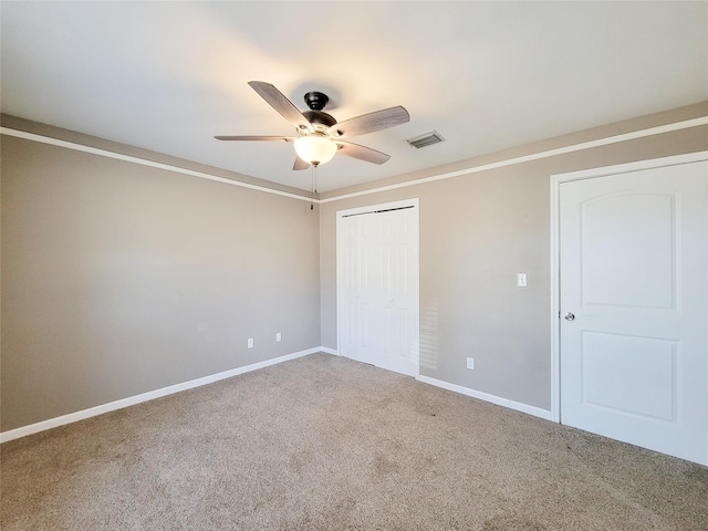 unfurnished bedroom with a ceiling fan, visible vents, baseboards, a closet, and carpet