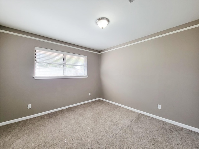 empty room with carpet flooring and baseboards