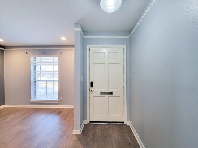 doorway featuring recessed lighting, baseboards, and wood finished floors