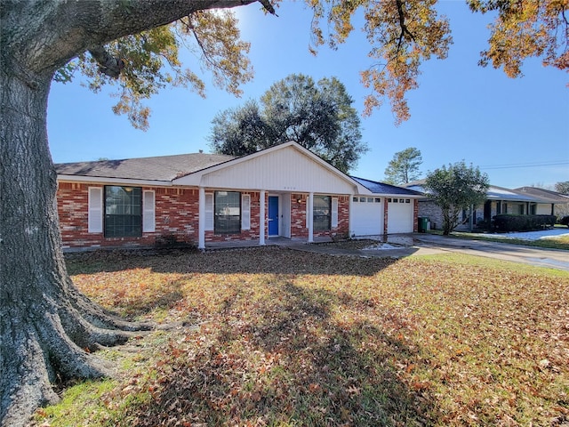 ranch-style house featuring driveway, a garage, brick siding, a porch, and a front yard