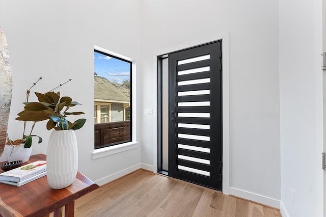 entrance foyer with light wood-style flooring and baseboards