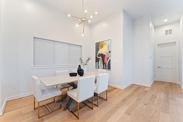 dining room featuring visible vents, baseboards, light wood finished floors, recessed lighting, and a chandelier